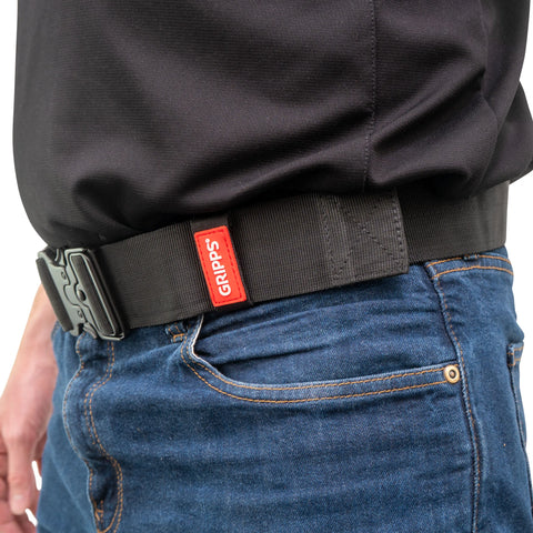 Person wearing GRIPPS Lite Belt seen side on standing against a white background